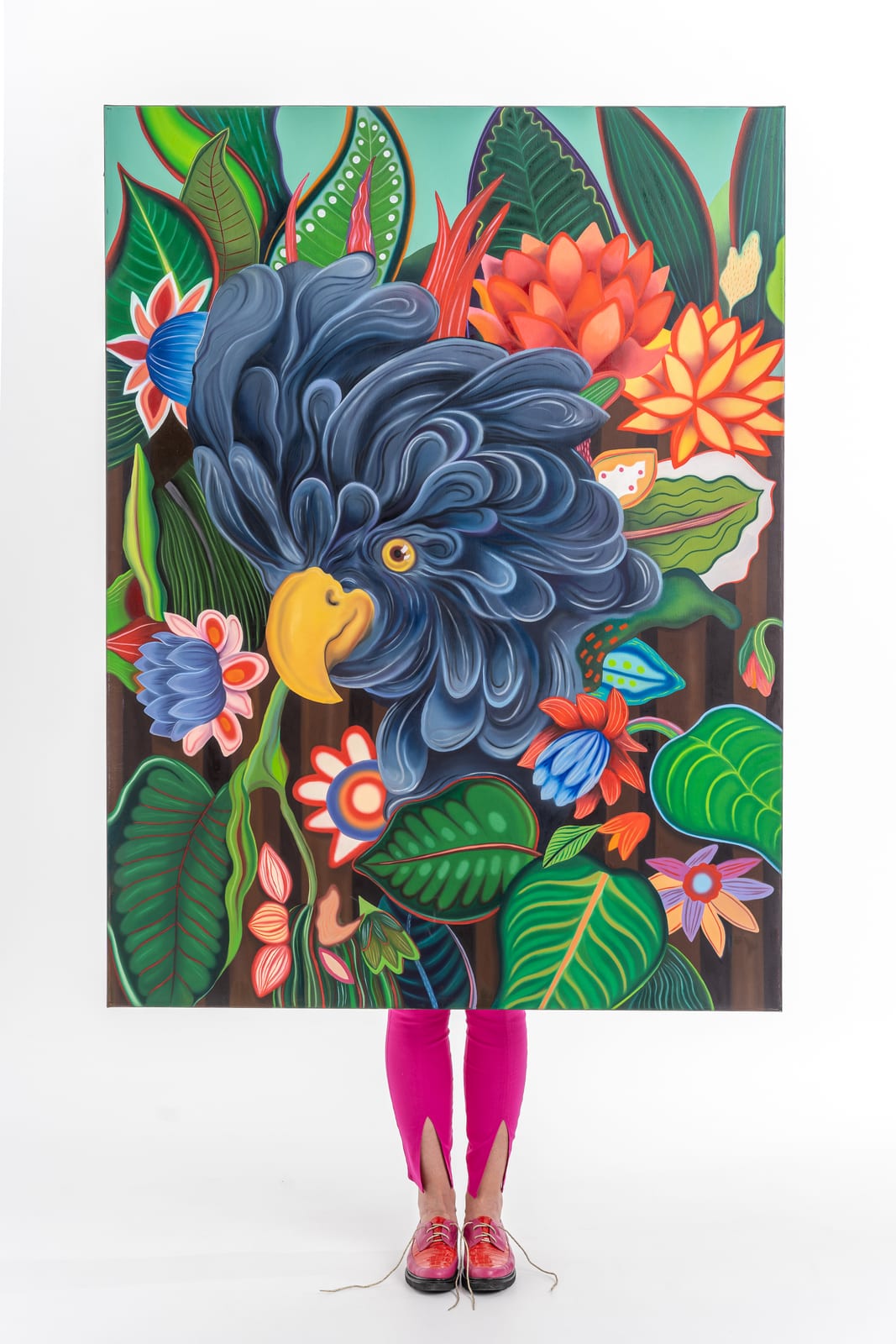 Magda holding an original Mad Mojo painting